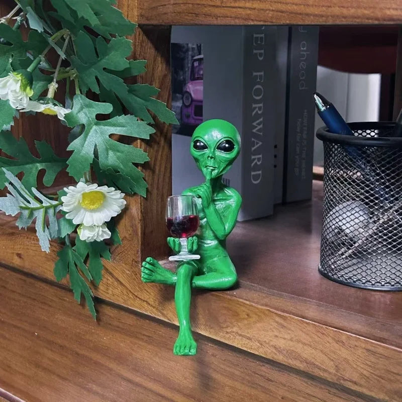 Alien figurine holding wine glass sci-fi decor