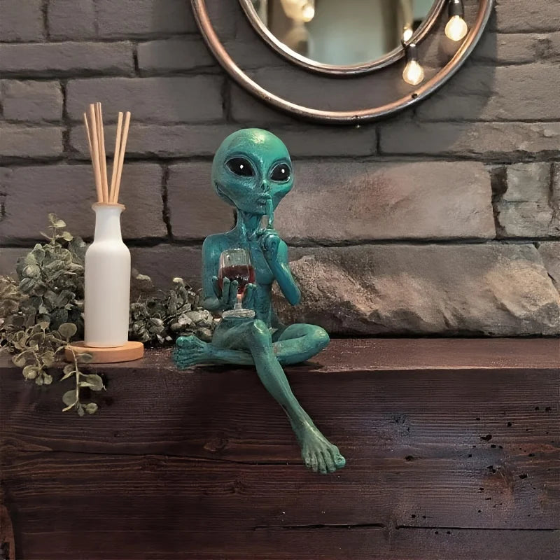 Alien figurine holding wine glass sci-fi decor